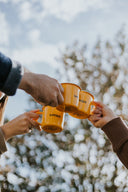 Trois mugs GIMBER qui trinquent sous un ciel d’hiver